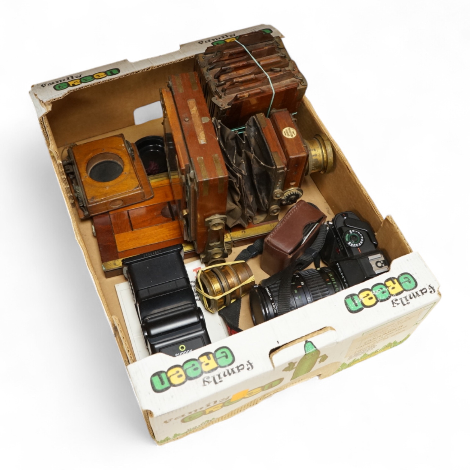A Pentax P30 camera with Sunpak auto 2000DZ flash and instruction manual, together with an early 20th century mahogany cased quarter plate camera with accessories including lenses, a separate shutter unit, and four negat